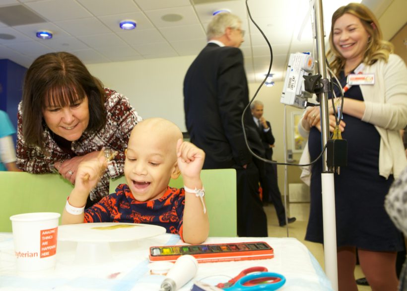 Second Lady Karen Pence compliments a child's art during an art therapy session.