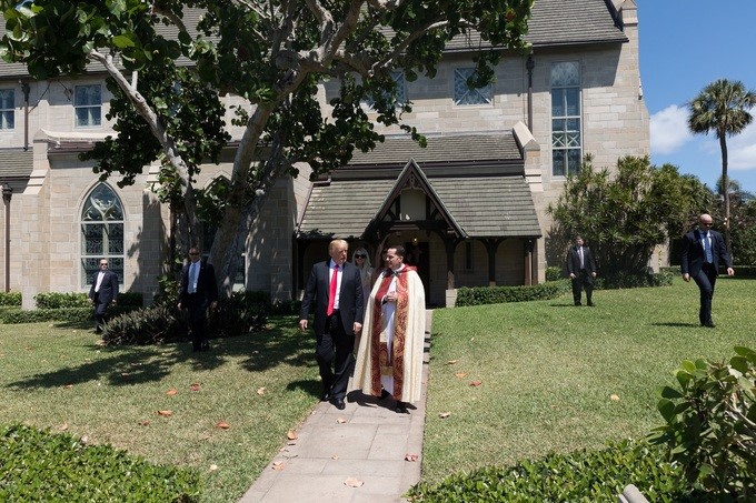 President Donald J. Trump walks with Rev. James R. Harlan, rector of the Church of Bethesda-by-the-Sea, following Easter church service, Sunday, April 1, 2018, in Palm Beach, Florida.